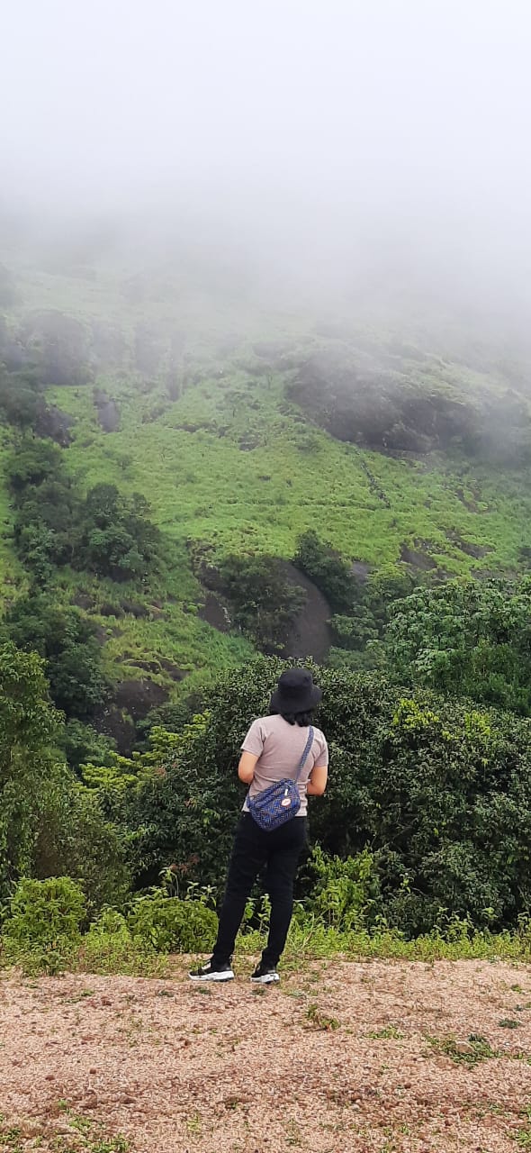 Standing at the location of the echo point in Vagamon where shouts are reverberated 